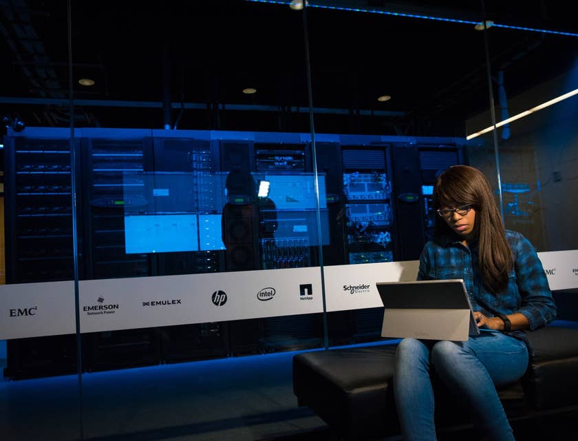 Cloud Engineer sitting outside the server room while running system tests