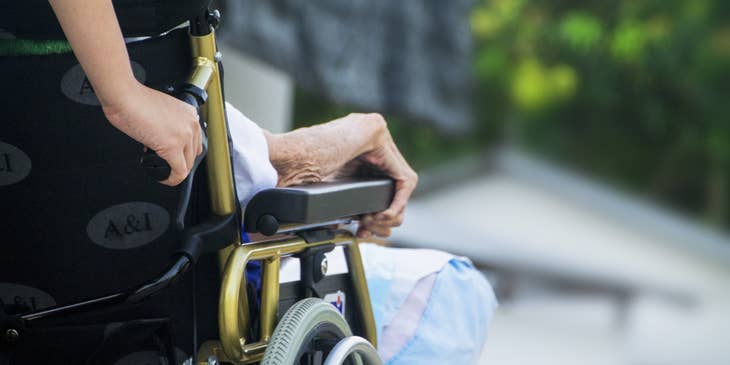 A certified nursing assistant assisting an elderly on his morning routine.