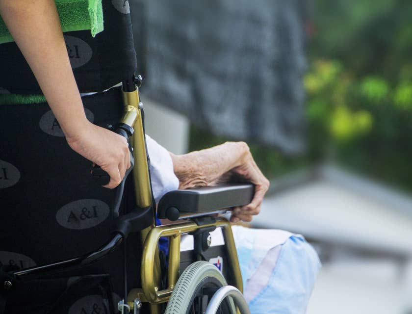 A certified nursing assistant assisting an elderly on his morning routine.