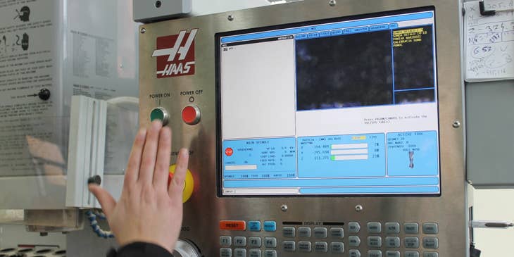 A CNC Machinist creating data instructions for a machine using a computer software.