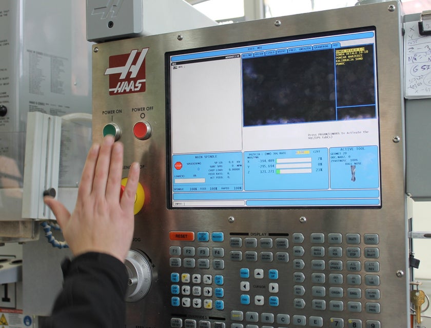 A CNC Machinist creating data instructions for a machine using a computer software.