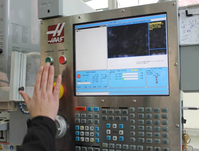 A CNC Machinist creating data instructions for a machine using a computer software.