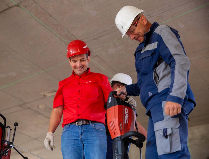 Commercial Project Manager with one of his team members trying out their driller.