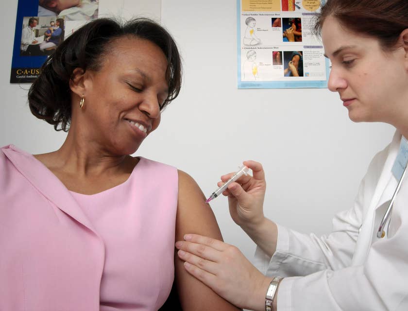 Company nurse administering vaccine to an employee.