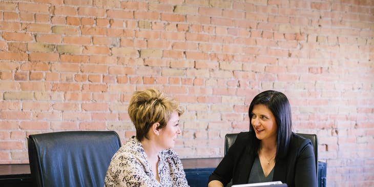 A Compensation and Benefits Manager talking to a colleague regarding policies.