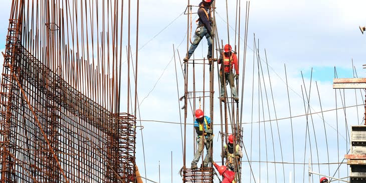 Construction workers assembles temporary structures.