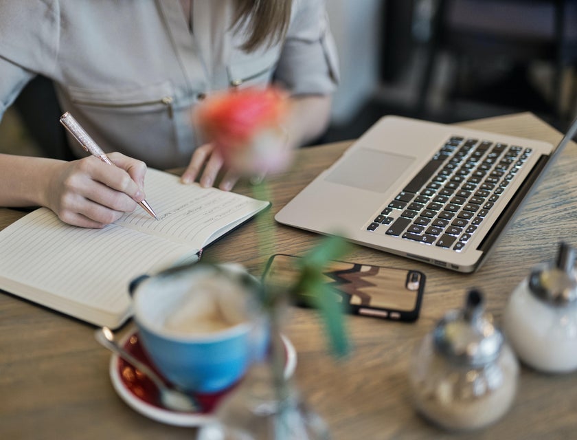 Content Writer taking notes while researching the web for new and fresh contents