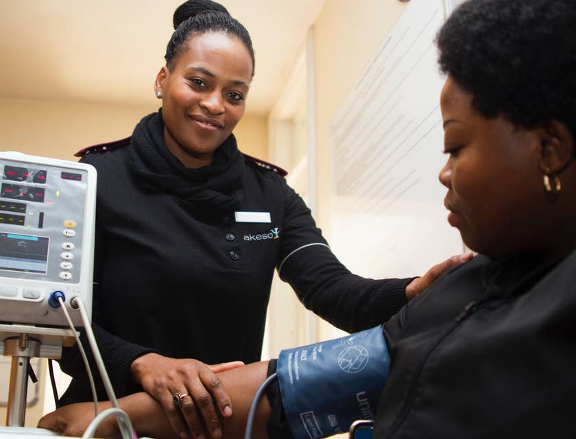 Continuous Care LVN taking vital signs to patient.