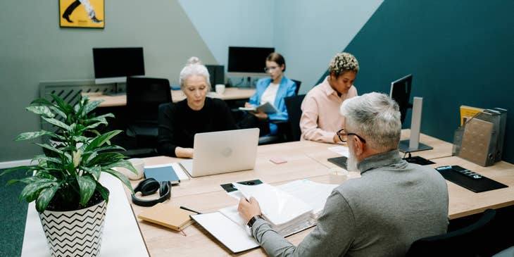 A Contract Administrator collaborating with the management team to ensure compliancy.