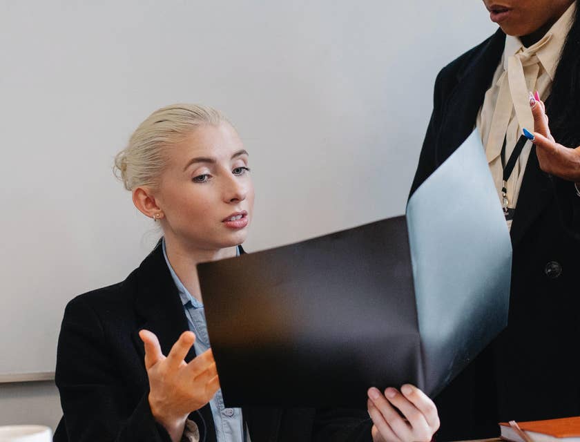 female Corporate Accountant discussing the details of the recent financial report with her colleague