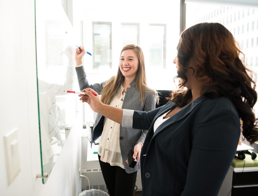 Corporate Trainer writing new training curriculum during their session with an employee