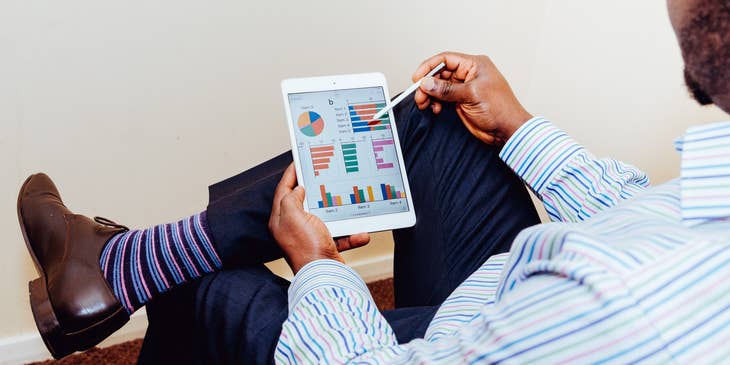 Cost Analyst looking at a graph report through his tablet