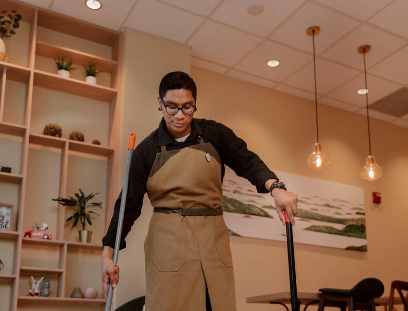 Courtesy Clerk making sure the establishment is clean and tidy