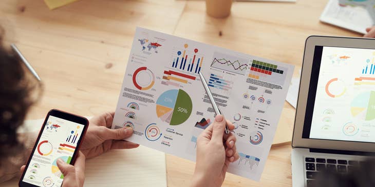 Credit Analyst sharing a paper report to a colleague