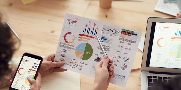 Credit Analyst sharing a paper report to a colleague