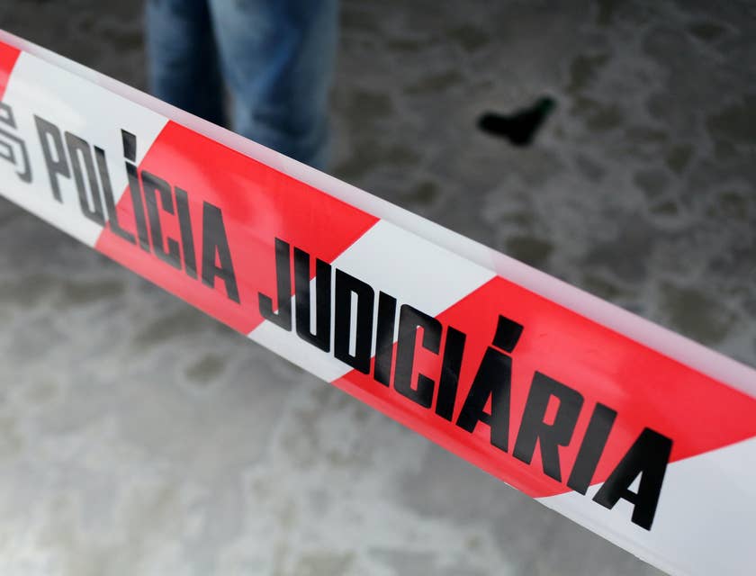 A Crime Scene Investigator standing in a crime scene about to collect evidences and transport them to the laboratory for analysis.