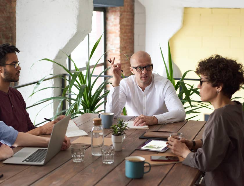 CTO deliberating with his team and sitting inside the conference room