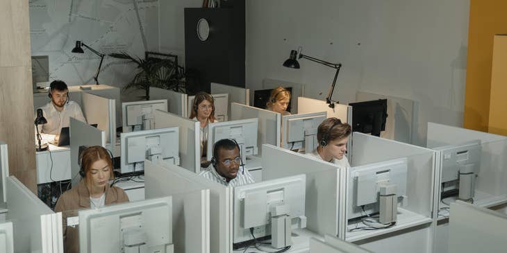a team of Customer Service Specialists taken during work hours while they are sitting on their respective workstations