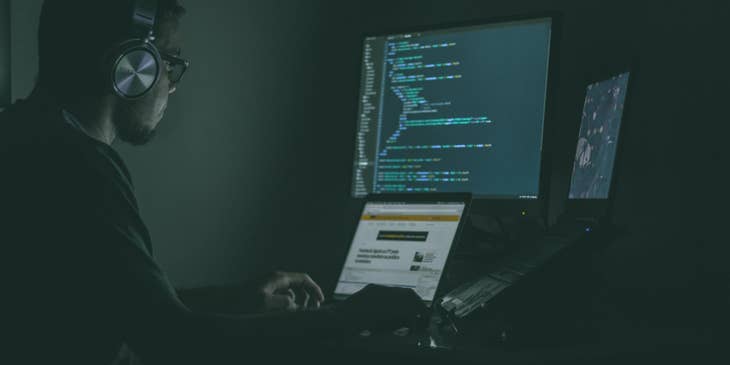 Cyber Security Engineer sitting at his workstation and monitoring the results of penetration tests to the system