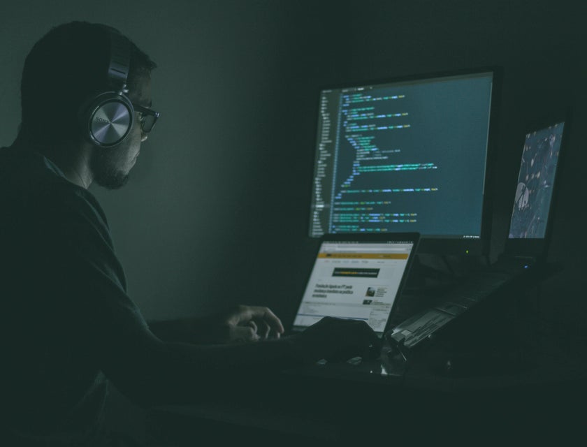 Cyber Security Engineer sitting at his workstation and monitoring the results of penetration tests to the system