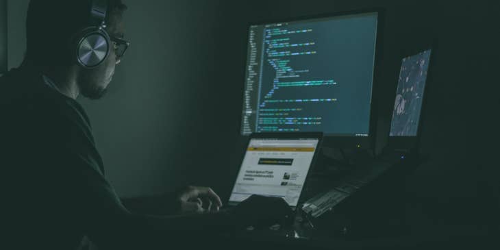 Cyber Security Engineer sitting at his workstation and monitoring the results of penetration tests to the system