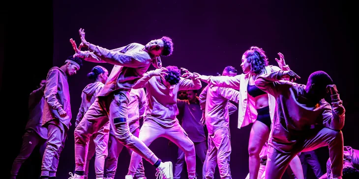 A group of dancers performing on stage.