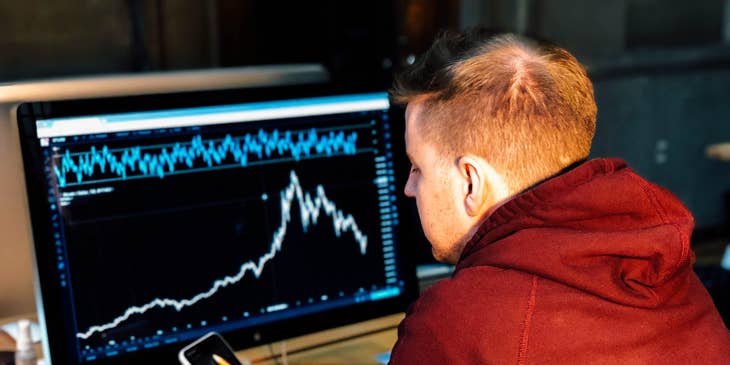 Data Architect sitting at his workstation and monitoring the new program he installed for the company
