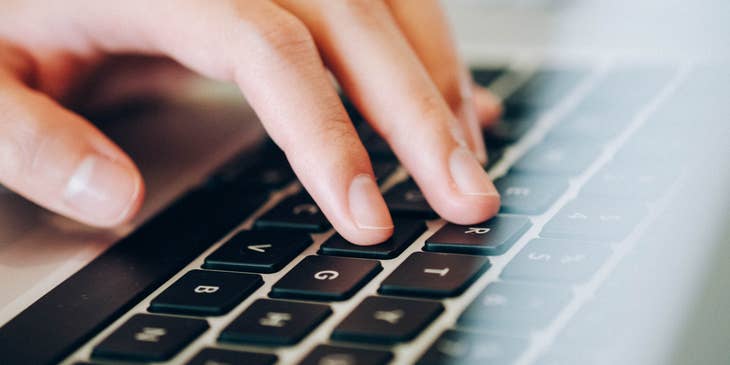 A person typing on a keyboard and entering data into a computer.