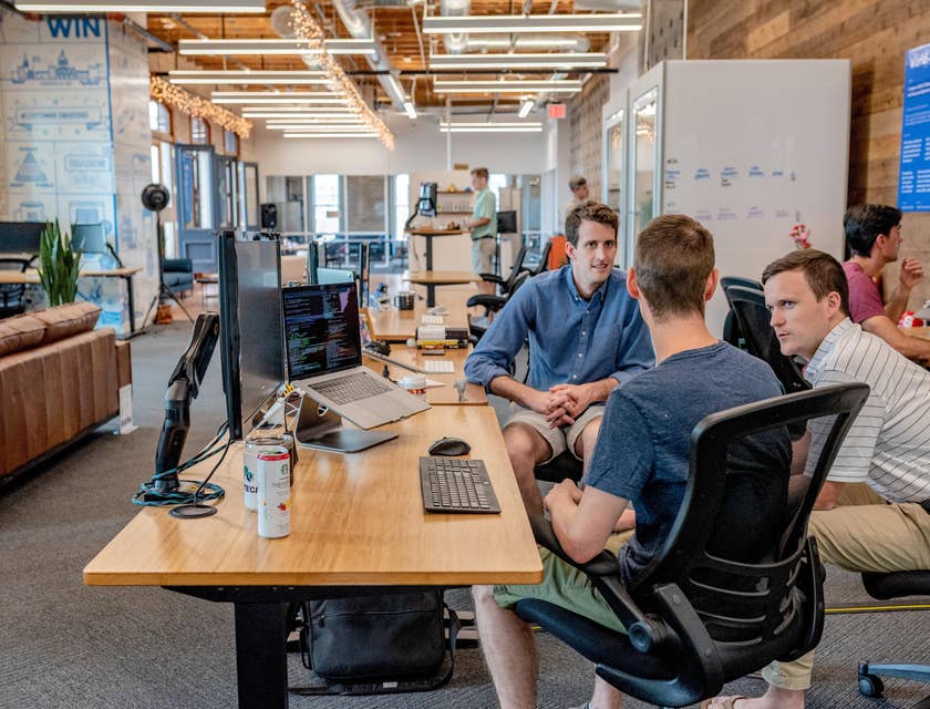 a team of Data Modelers discussing the database design they are working on for a startup company
