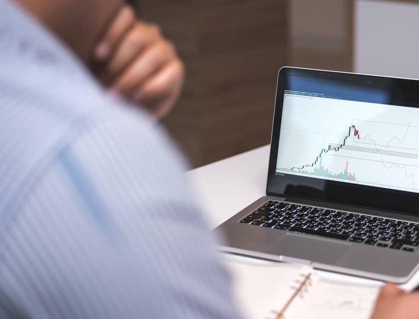 Data scientist working at a desk with a laptop.