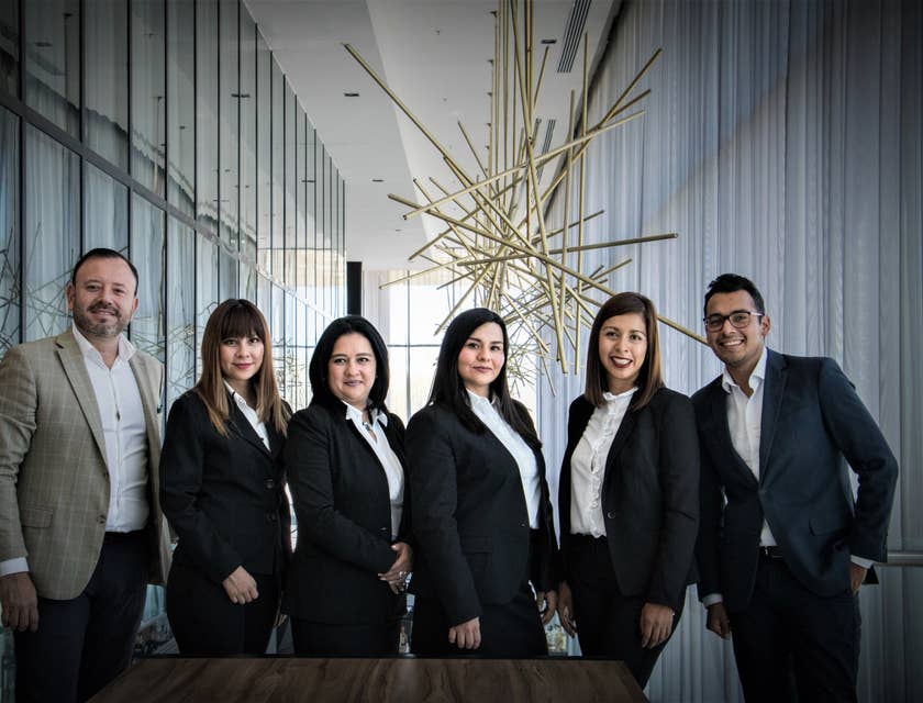 photo of the Debt Collector team wearing business attire taken on an office hallway