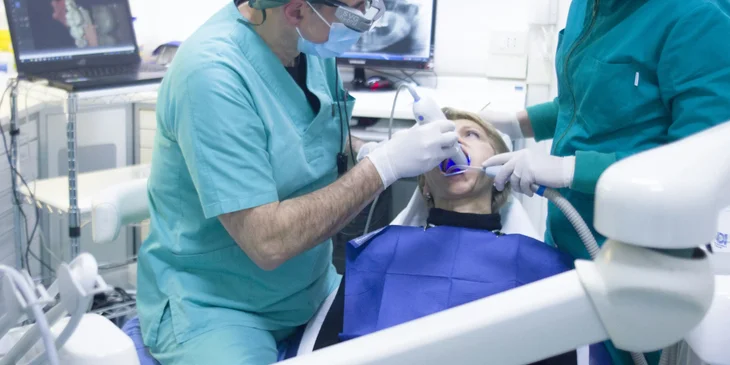 A dental assistant assisting with a dental procedure.