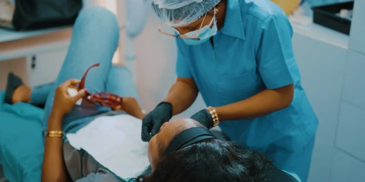 A dental assistant preparing a patient for a procedure.