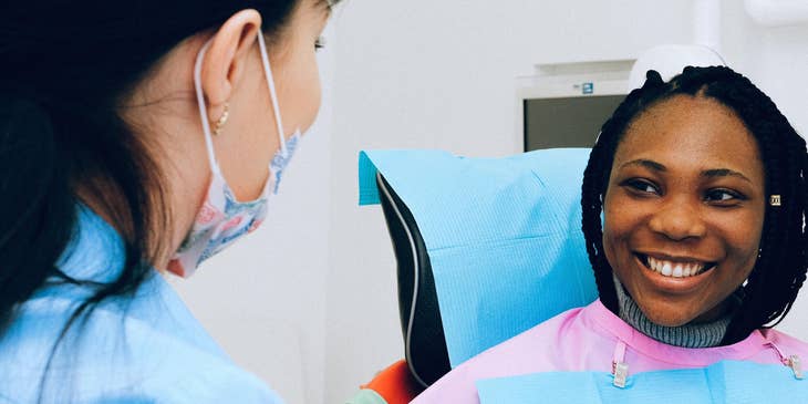 woman having a checkup by a dental hygienist