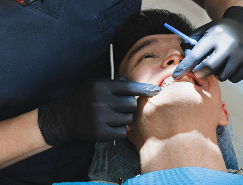 Dental Hygienist examining gums for signs of disease and other dental health issues.