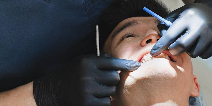 Dental Hygienist examining gums for signs of disease and other dental health issues.