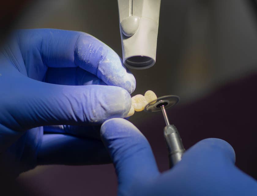Dental Laboratory Technician polishing dental prostheses.