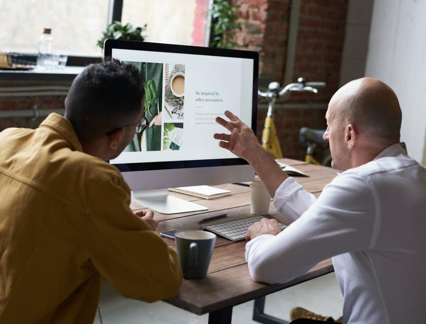 young Digital Designer presenting his final product with his client while he gives him feedback regarding the design