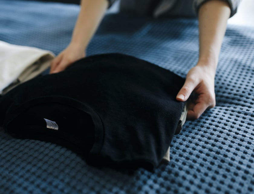 Direct Care Worker prepares the client's clothes before going on a trip.