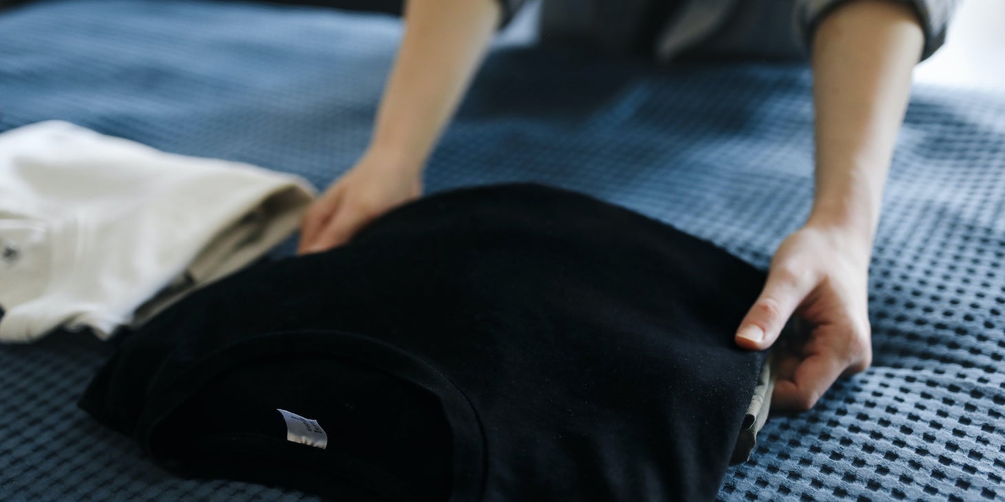 Direct Care Worker prepares the client's clothes before going on a trip.