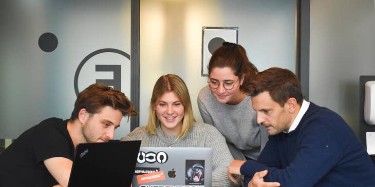 Female Director of Marketing showing the new campaign to her team inside the conference room