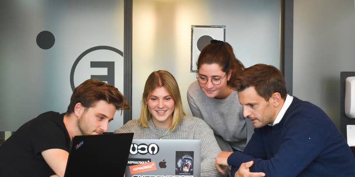 Female Director of Marketing showing the new campaign to her team inside the conference room