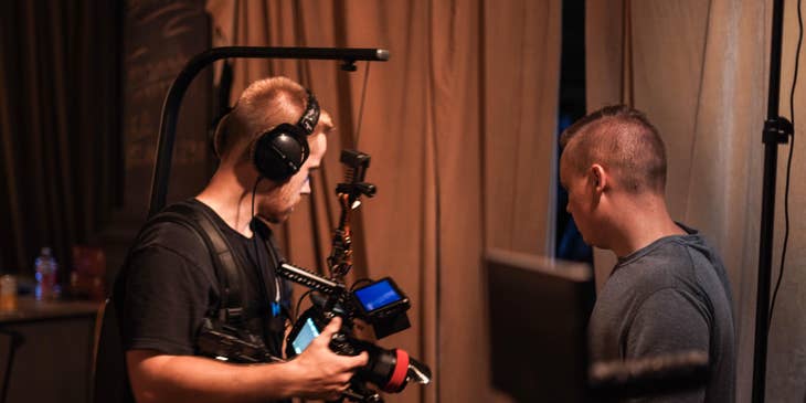 Director of Photography giving instructions to the cameraman for the best on where to position