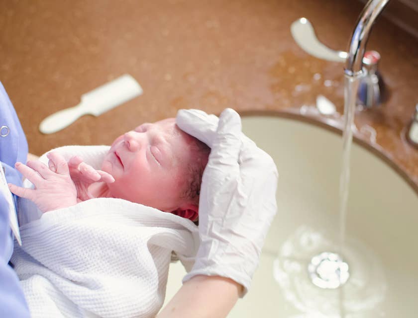 Doula bathing assists in bathing a baby while the mother heals.