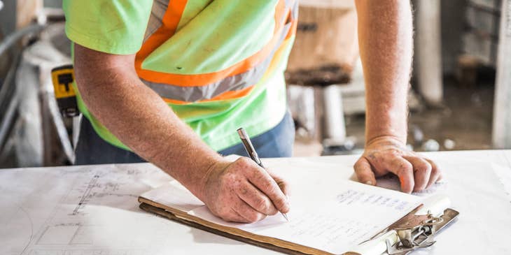 Electrical Estimator writing on a clipboard