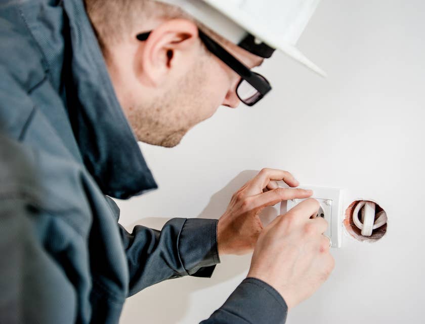 Electrician repairing an electrical outlet