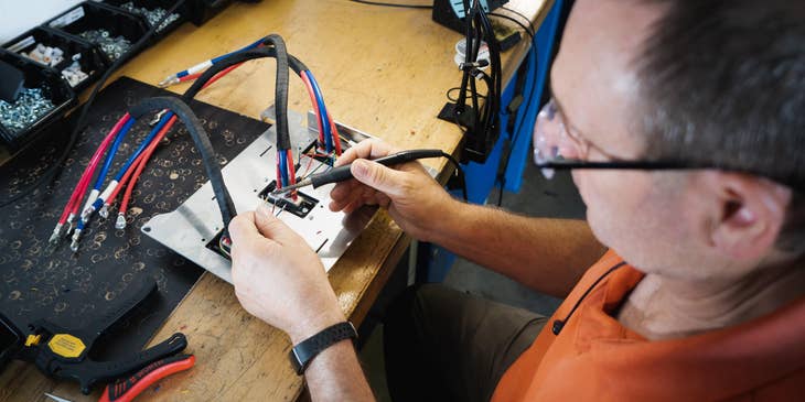 Electronics technician fixing cables