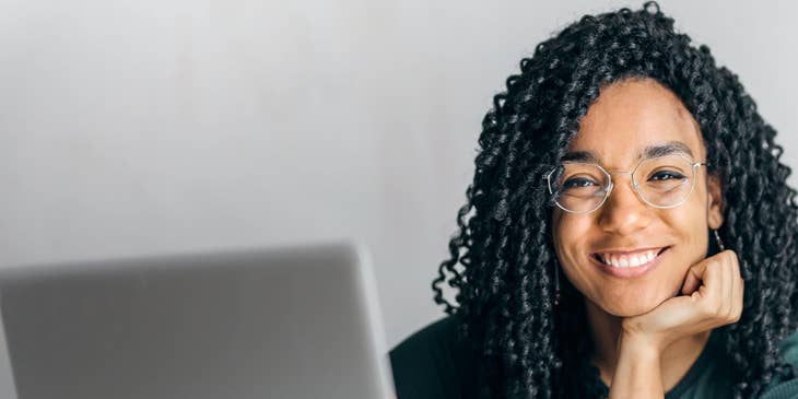 Woman siting at laptop creating employee recognition Ideas