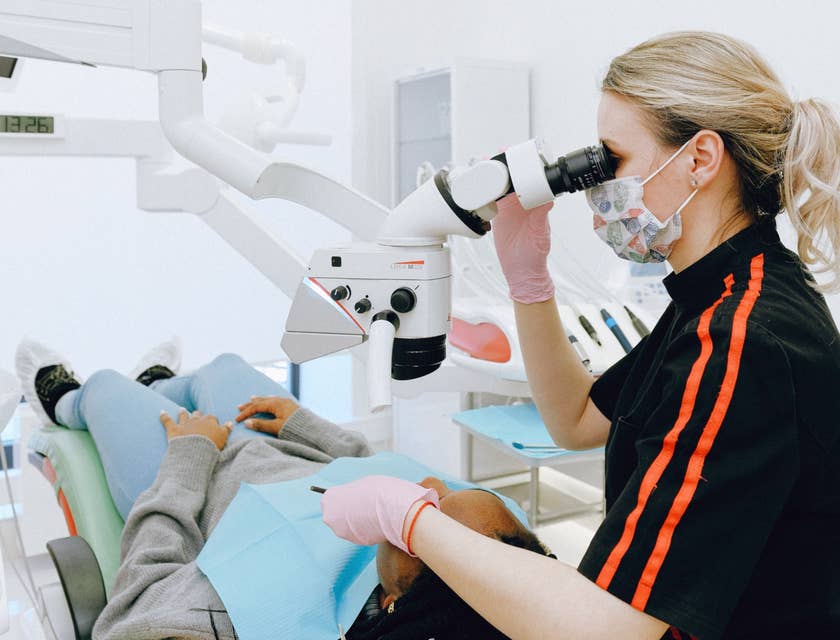 Endodontist utilizing dental instruments to determine the cause of patients' oral pain.