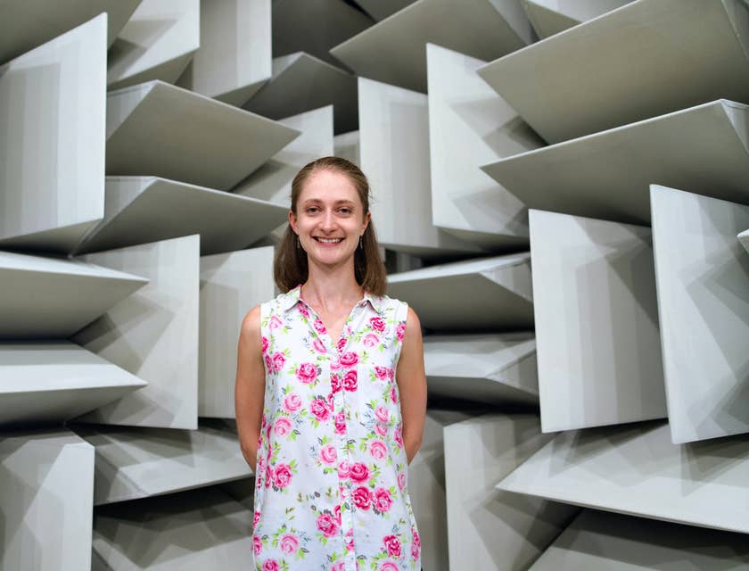 female Engineer smiling and standing behind her own architectural design